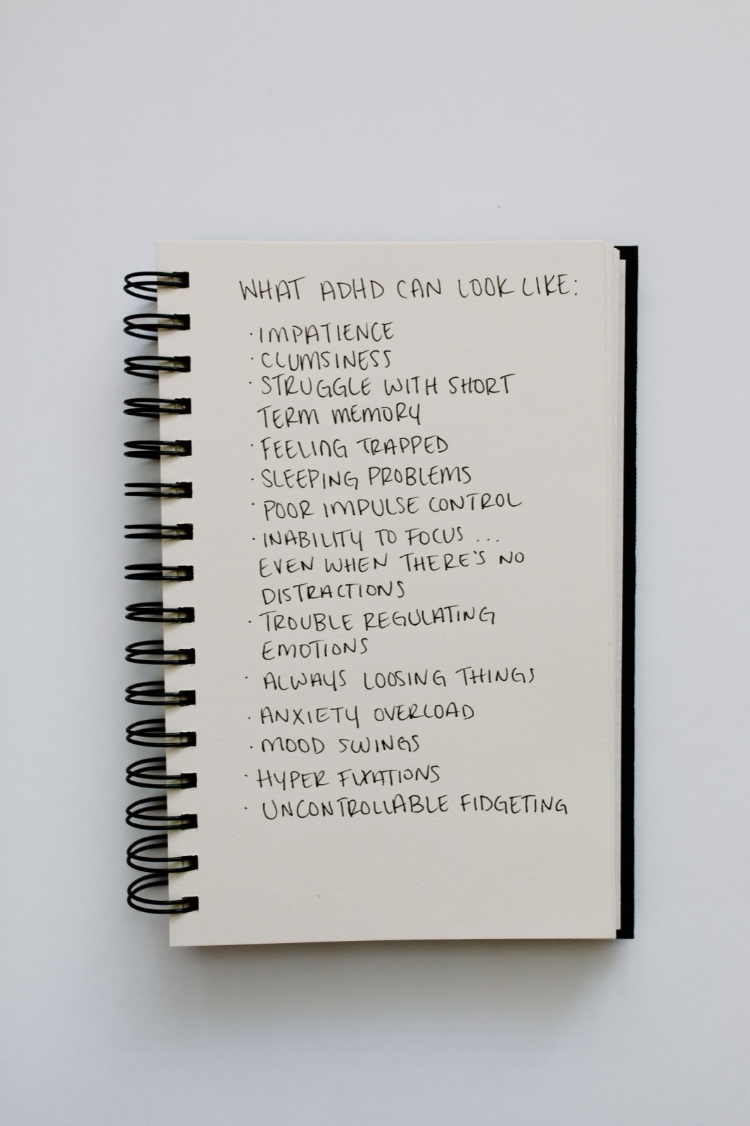 A notebook listing what ADHD can look like