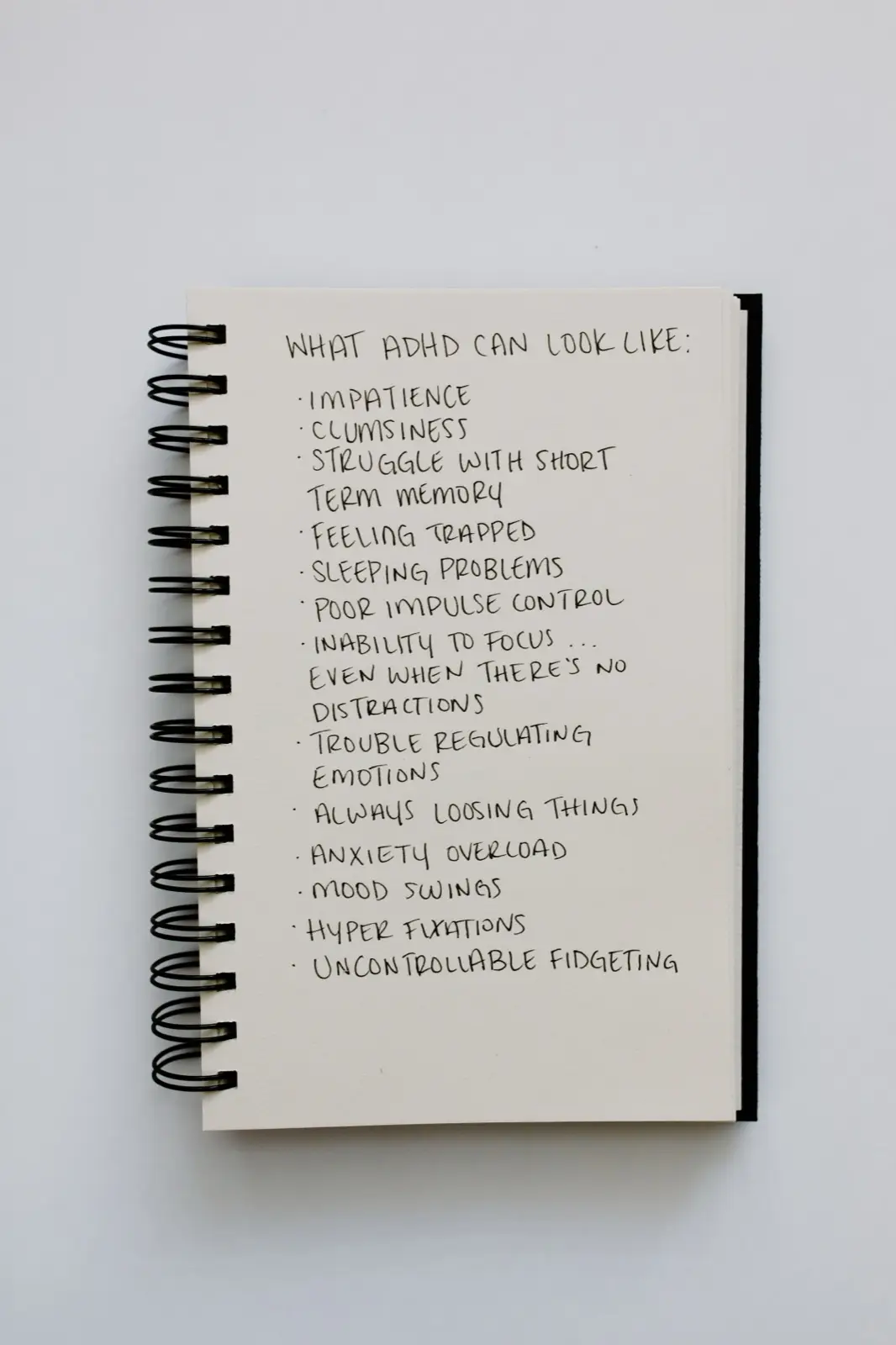 A notebook listing what ADHD can look like