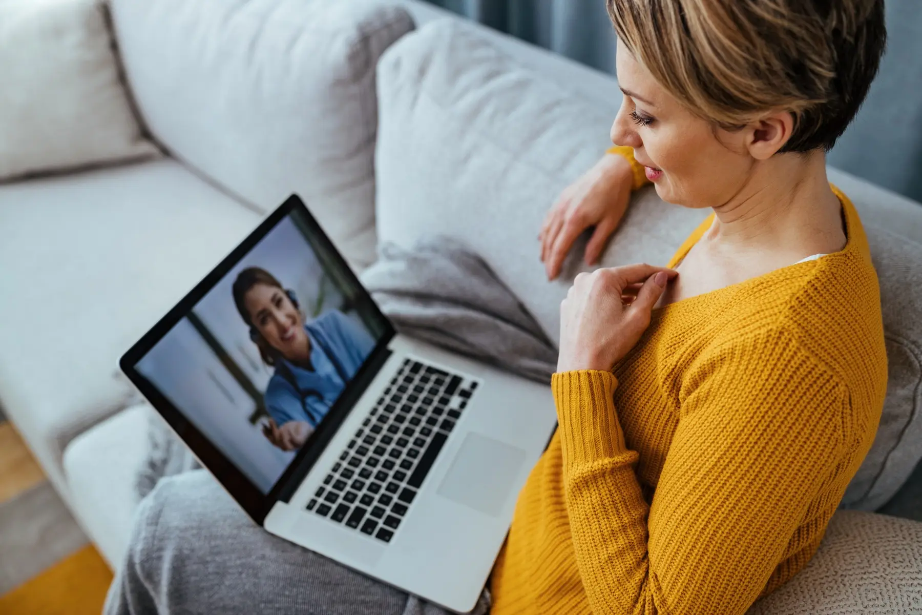 A woman on a video visit with her doctor from home